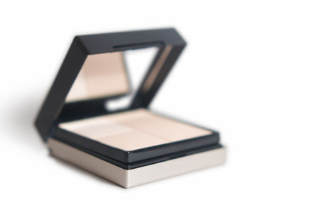 Close-up of a box of foundation on white background. Very shallow depth of field. Ideal for use as conceptual background image.の写真素材