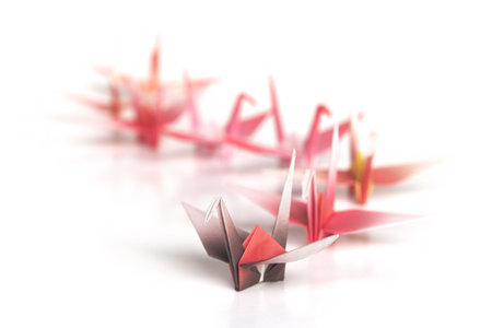 A queue of origami birds on a white backgroundの写真素材