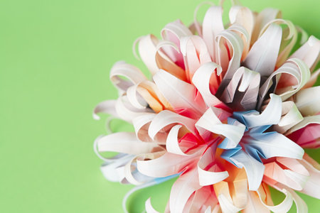 Multicolour origami flower ball on a green backgroundの写真素材