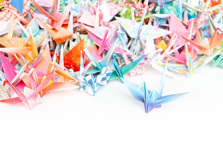 Photo of a pile of origami cranes on a white background. Shallow depth of field. の写真素材
