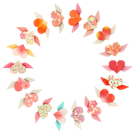 Paper folded winged-hearts arranged in a circle shape, isolated on a white background の写真素材