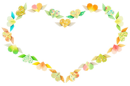 Paper folded winged-hearts arranged in a heart shape, isolated on a white background の写真素材