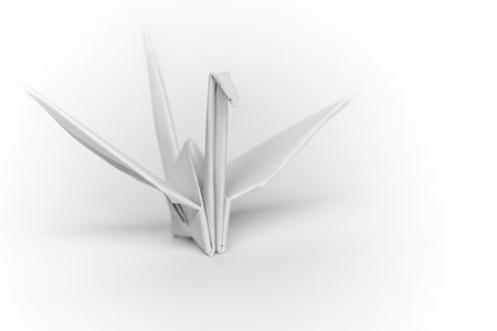 A white paper bird on a white background, shallow depth of field の写真素材