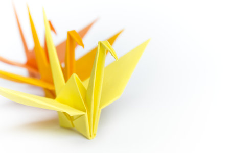 Three paper birds lining up on a white background, shallow depth of field  の写真素材
