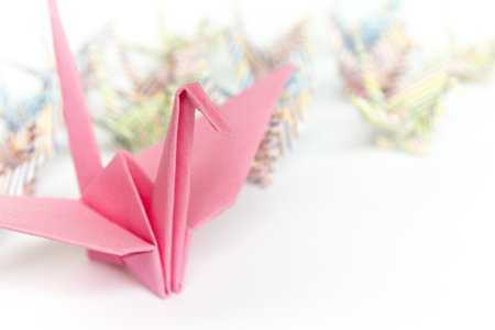 A big pink paper bird and a group of small paper birds, shallow depth of field の写真素材