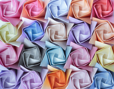 Top view of twenty colourful paper roses arranged as a decorative background の写真素材