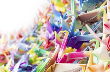 Colourful paper birds hanging together using fishing lines. Shallow depth of field. の写真素材