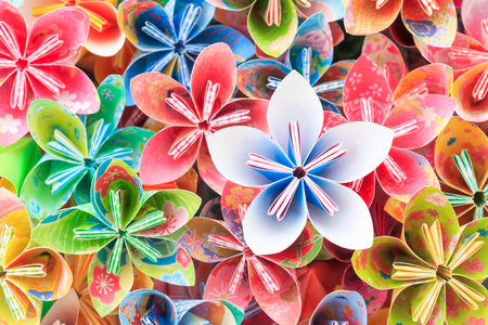 A pile of colourful Japanese Kusudama flower pieces. Shallow depth of field. Focus on the blue/pink flower on top of the pile.の写真素材