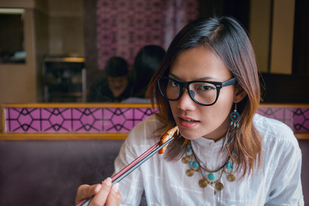 Asian women eating lunch with hunger.の写真素材