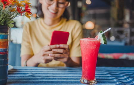 Pictures of watermelon and Asian women are happy to relax.Focus on Glassの写真素材