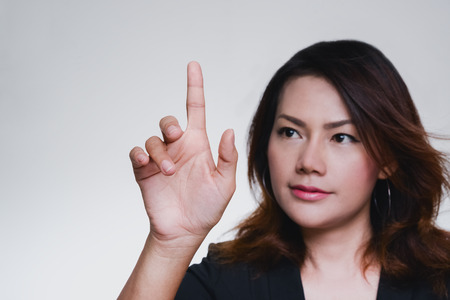 Asian  business show hand touch screen virtual background concept.focus on handの写真素材