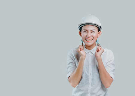 Asian women wear a helmet and have a smiling face in the studio.Focus on faceの写真素材