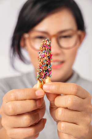 Close-up picture of  Asian woman holding a snack.Happy mood,Focus on hands