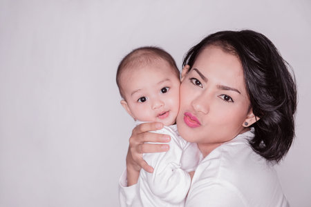 Asian woman and son hugging each other In a happy mood, Focus on mom's face