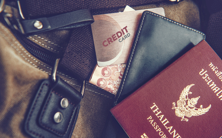 Wallet, passport, credit cards placed on the bag.の写真素材