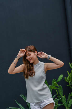 Happy Girl Enjoying Music And dancing Favourite Song, Relaxing travel outside.の写真素材