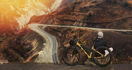 Active male cyclist riding bike on a mountainの写真素材