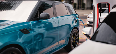 Modern electric vehicles plugged into a public charging station in a city, highlighting the shift towards sustainable transportation.

 3d, rendering, illustration,の写真素材