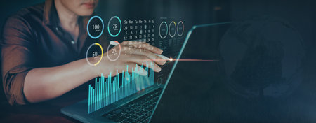 Hands typing on a laptop with futuristic virtual data interface. Perfect for technology, analytics, and innovation themes.の写真素材