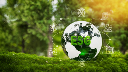 Green Earth with ESG letters placed on lush grass, surrounded by eco-friendly and sustainability icons, with a forest background and sunlight. Concept of environmental, social, and governance responsibility for a sustainable future.の写真素材