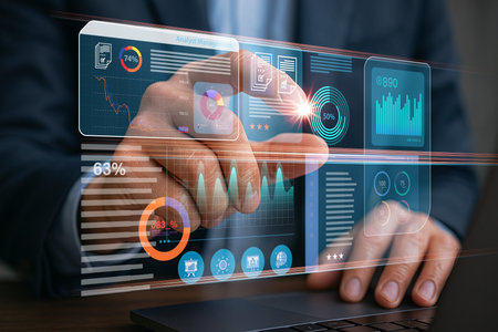 Businessman using a futuristic virtual interface with data visualization, analytics charts, and...