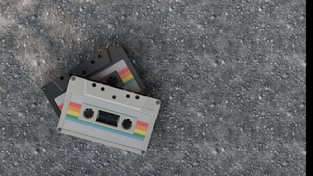 Vintage cassette tapes on gray rocky texture retro background concept of analog music nostalgia and old recording soundの写真素材
