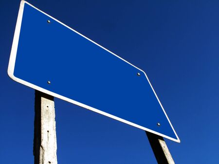Empty road sign against a background of blue sky の写真素材