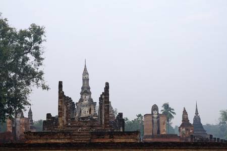 Buddha sit on ruins temple in Sukhothai historical park have stupa backgroundの写真素材
