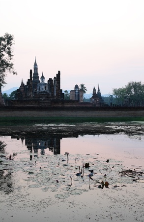 Buddha sit on ruins temple shadow on the waterの写真素材
