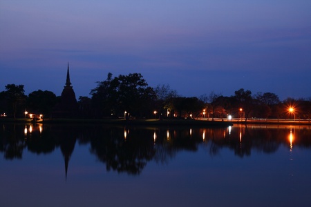 Buddha sit on ruins temple shadow on the water Nightの写真素材