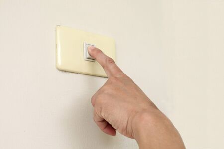 Finger turning off or turning on the wall-mounted light switch