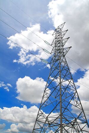 High-voltage towers under blue sky.の写真素材