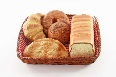Bread in the basket on white isolated background.の写真素材