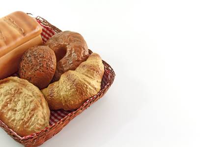Bread in the basket on white isolated backgroundの写真素材