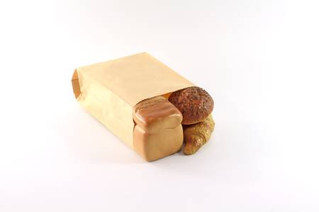Bread in the paper bag on white isolated background.の写真素材