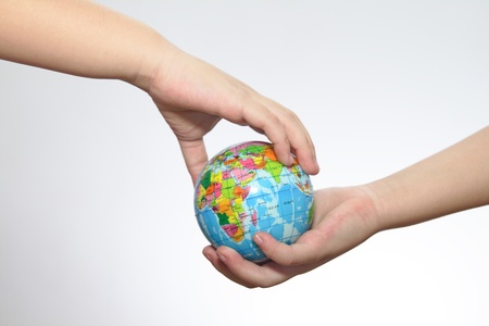 The globe in hands of the child.
