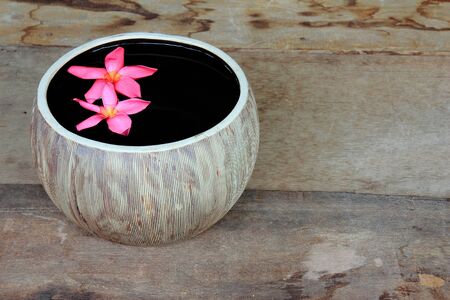 Image of spa  flowers in water on the old wooden desk.の写真素材
