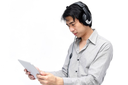 Tablet on hand businessman with headphoneの写真素材