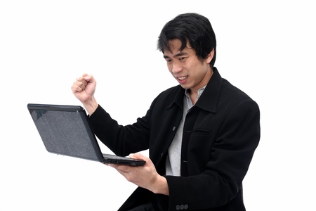 Businessman panic while looking at laptopの写真素材