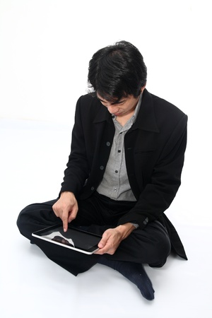 Businessman relax sitting with a digital tabletの写真素材