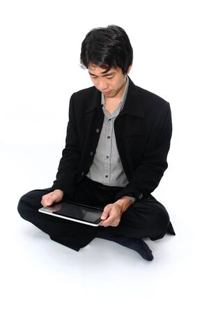 Businessman relax sitting with a digital tabletの写真素材