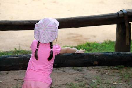 Rear view little asian girl with pink dressの写真素材