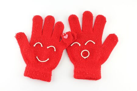 Pair of red winter gloves with happy faceの写真素材
