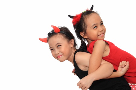 Scary cute little asian girl in black and red Halloween costume.の写真素材
