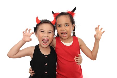 Scary cute little asian girl best friend in black and red Halloween costume.の写真素材