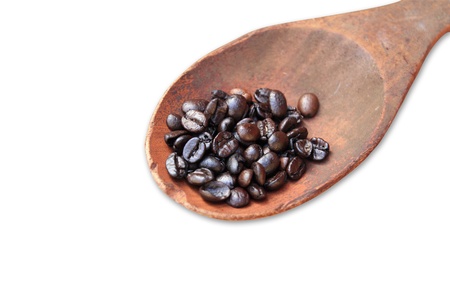 coffee beans on wooden spoon on isolated white backgroundの写真素材