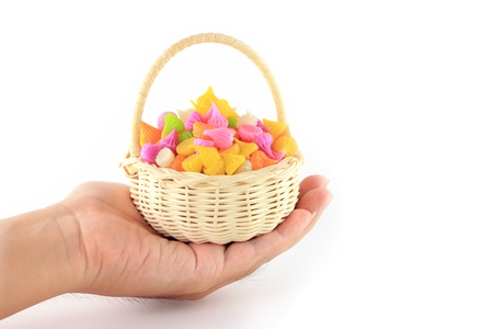 Hand holding colorful sweetness Thai style dessert in basketの写真素材