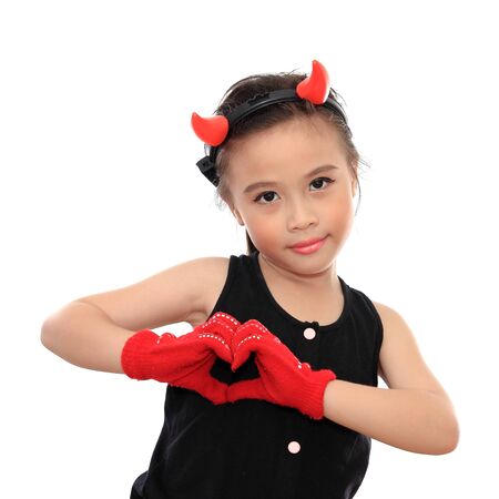 Beautiful little asian girl with heart signの写真素材