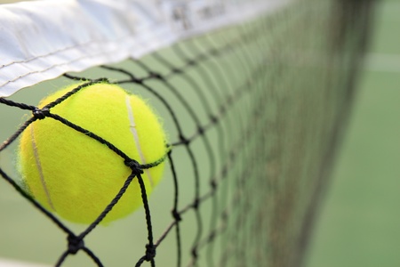 Tennis ball in netの写真素材