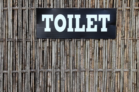 Public toilet sign on bamboo backgroundの写真素材
